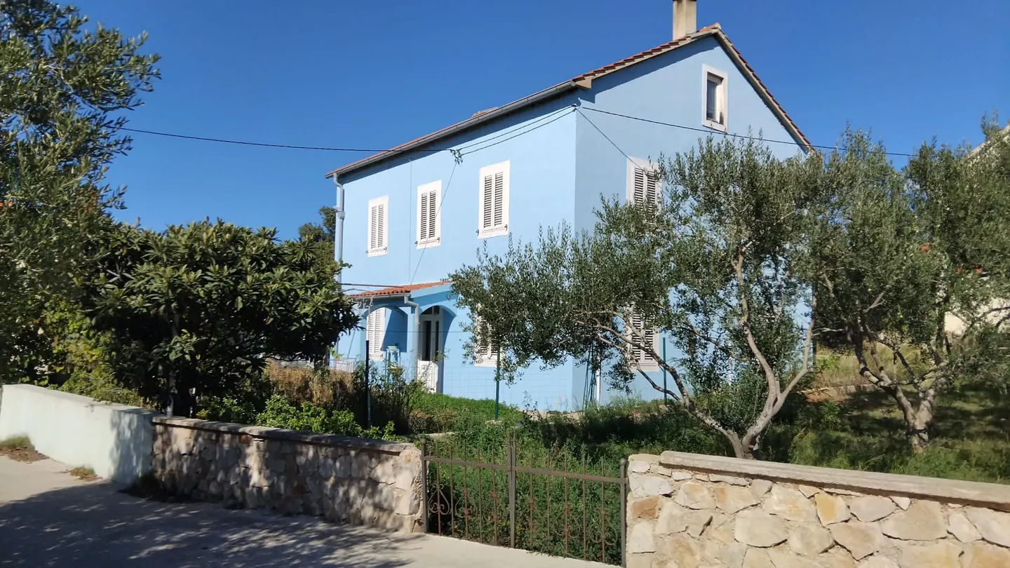 Blue House: a two-storey blue house with white shutters among olive trees on Olib