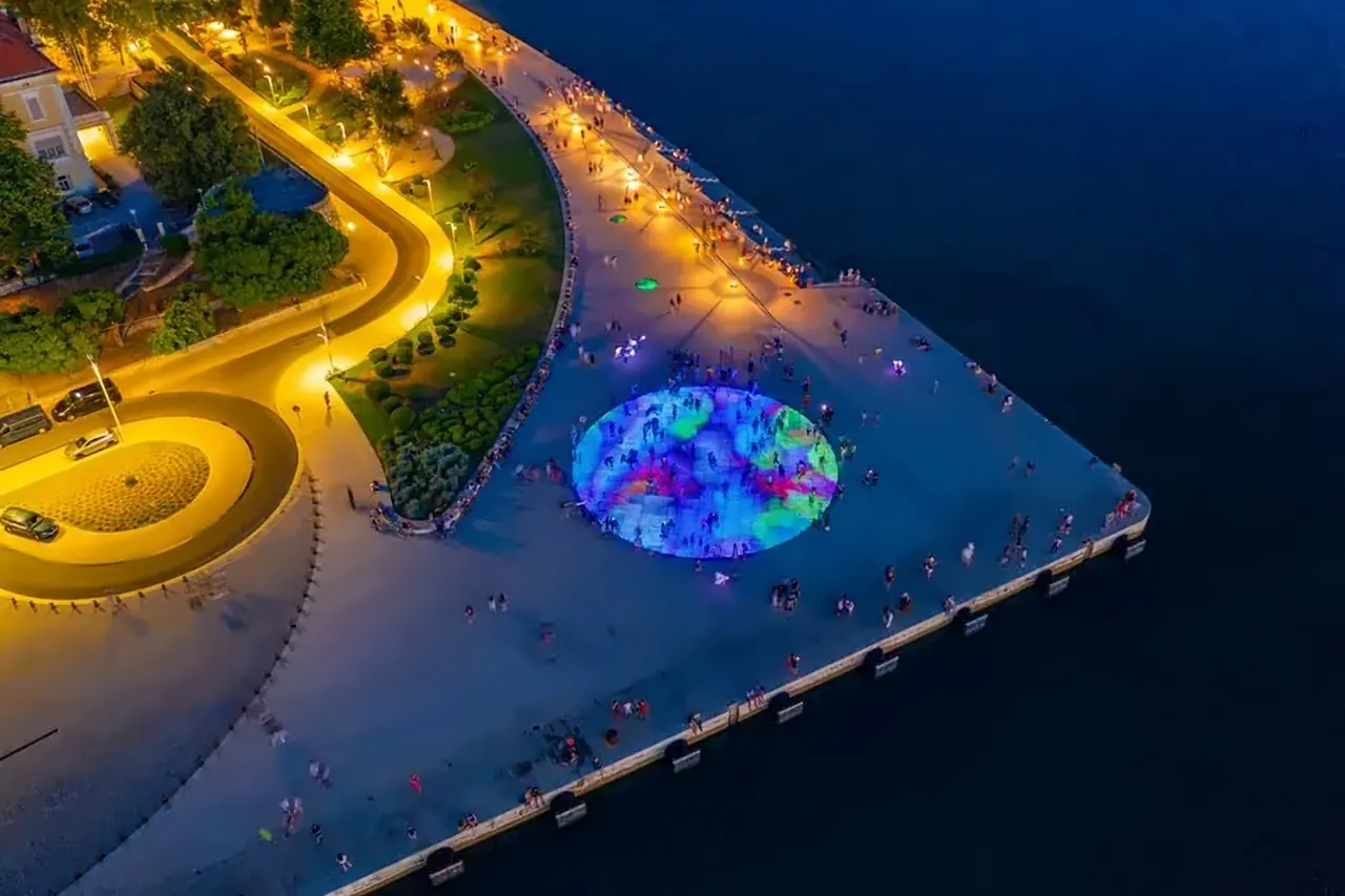 Aerial view of the Greeting to the Sun, a glowing circle of coloured light on the Zadar waterfront at dusk